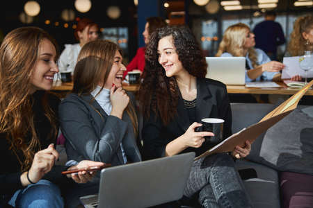 Cheerful business colleagues working together on new projectの写真素材