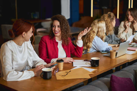 Cheerful business colleagues talking and smiling at workの写真素材