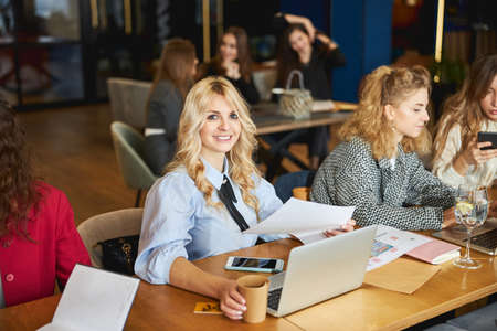 Attractive young woman working on business project with colleaguesの写真素材