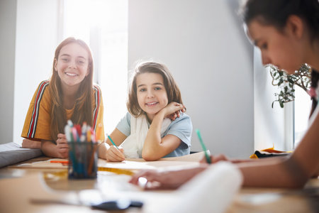 Adorable children drafting patterns in sewing workshopの写真素材