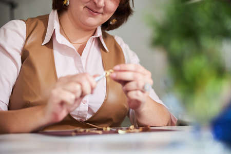 Craftswoman using a pair of pliers in her work