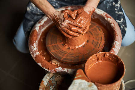 Senior woman hands working on pottery wheel in workshopの写真素材