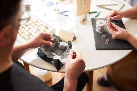 Two experienced jewelers working in their workshop