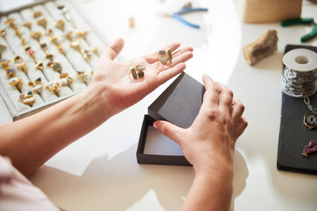 Professional jeweler demonstrating her gorgeous jewelry itemsの写真素材