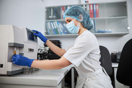 Skilled female biochemist conducting a biochemical analysis