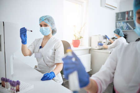 Female biochemist performing a complete blood count