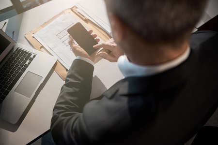 Male worker using mobile phone in office