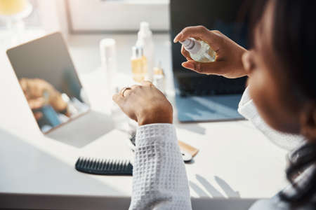 Young woman holding bottle of serum or essential oilの写真素材