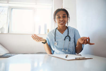Cheerful female doctor working in modern clinic