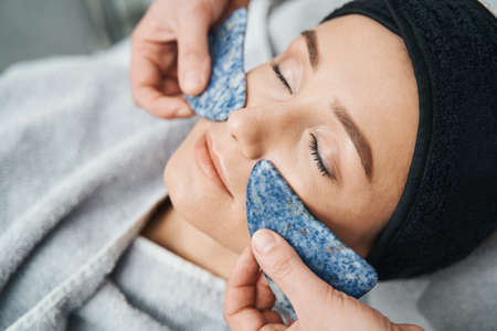 Female patient undergoing a gua sha treatment