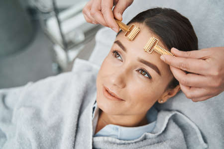 Relaxed spa client looking up during the facial massage