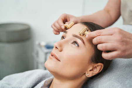 Patient skin being massaged with acupressure metal roller massagersの写真素材
