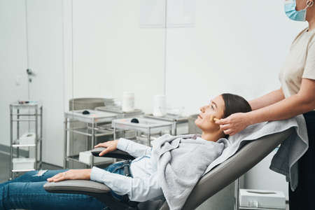 Patient being massaged with a metal roller massager