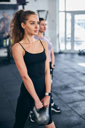 Two Caucasian sportswomen working out with weightsの写真素材