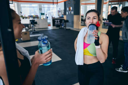 Two athletes restoring their electrolyte balance after the trainingの写真素材