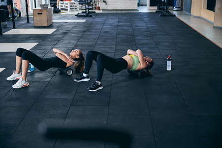 Professional female athletes relaxing their upper back musclesの写真素材
