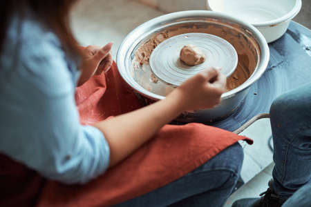 Female potter hands making pottery in workshop