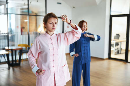 Clenching fists and coordinating movements at the practiceの写真素材