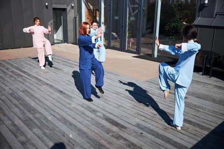 Practicing slow flowing movements of martial arts