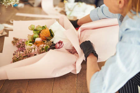 Skilled florist finishing off a floral arrangementの写真素材