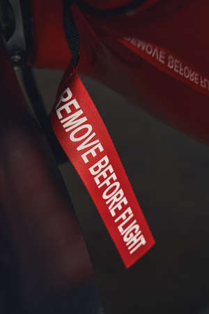 Remove before flight label on red aircraft