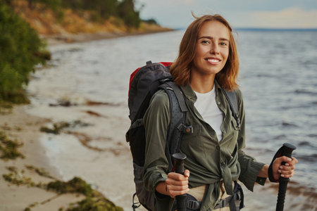 Caucasian woman smiling to camera during her beach hikeの写真素材