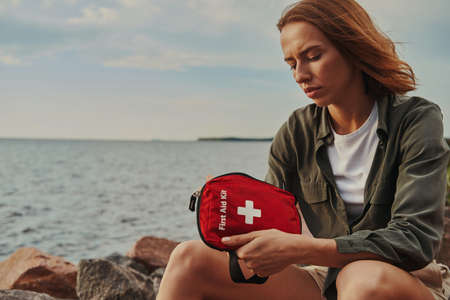 Tourist is sitting with first aid kitの写真素材