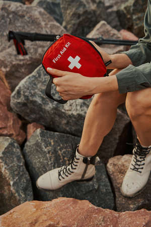 Person showing first aid kit to cameraの写真素材