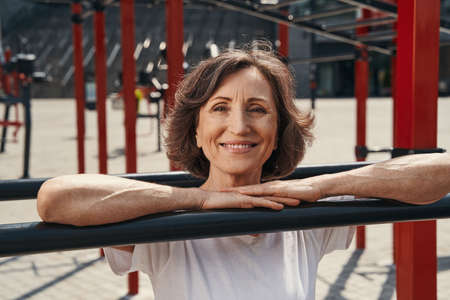 Happy mature female enjoying sporty day outdoorsの写真素材