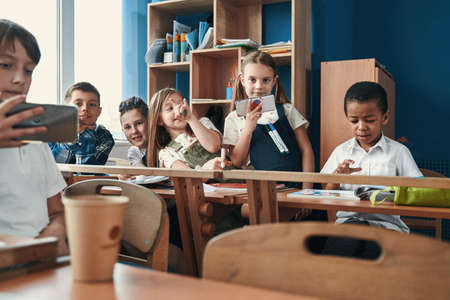 Relaxed classmates having fun at the school breakの写真素材