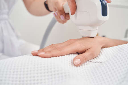 Woman during laser epilation process in beauty clinicの写真素材