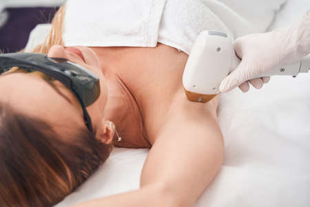 Young woman during armpit epilation in salonの写真素材