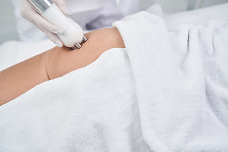 Woman during body massage procedure in salon