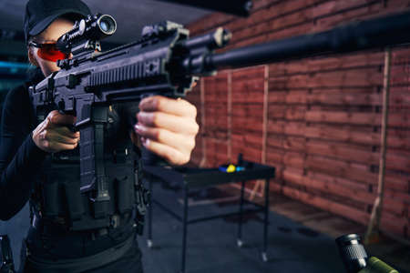 Concentrated professional shooter using a telescopic sight for target shooting