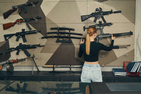 Experienced blonde saleslady choosing the right weapon for her clients