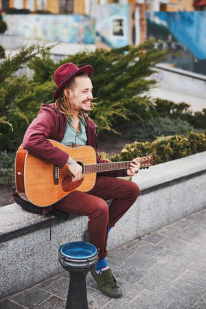 Kind informal guy entertaining people with instrumental musicの写真素材