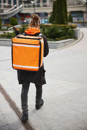 Busy courier looking for the address of delivery