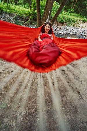 Joyful young female relaxing alone in natureの写真素材