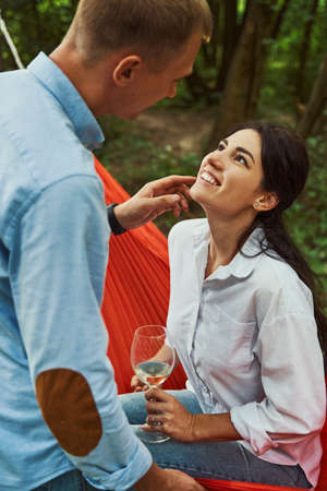 Young man cuddling with pretty girlfriend outdoorsの写真素材