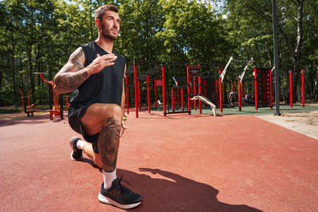 Motivated athletic male doing cardio training outdoors