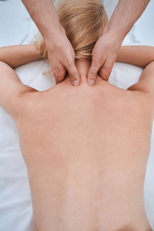 Female patient being treated for neck pain by a physiotherapistの写真素材