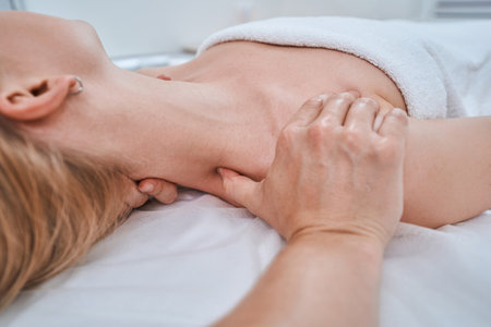 Spa client being treated for neck painの写真素材