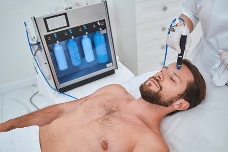 Young man undergoing a blackhead removal treatmentの写真素材