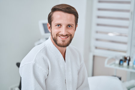 Joyous male spa client anticipating a cosmetic procedureの写真素材