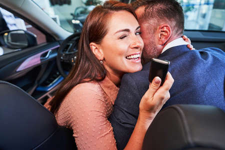 Happy lady becoming car owner and smiling