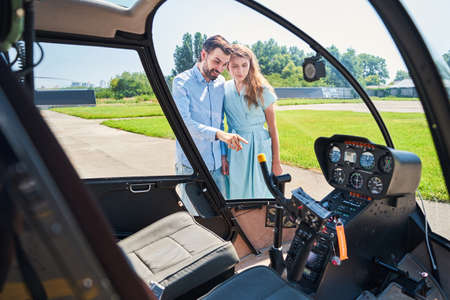 Contented guy demonstrating his private chopper to womanの写真素材