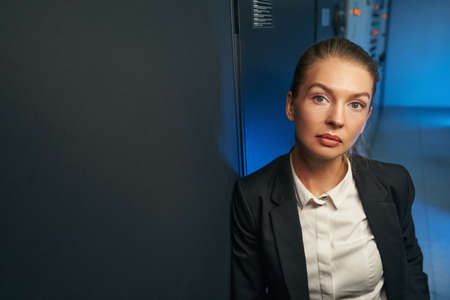 Attractive female network engineer standing in server roomの写真素材
