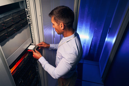 Skilled system administrator replacing old hardware componentの写真素材