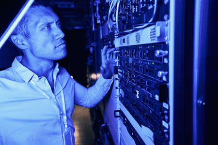 Focused data center employee monitoring equipment performanceの写真素材