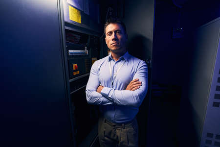 Young male technician standing in server room